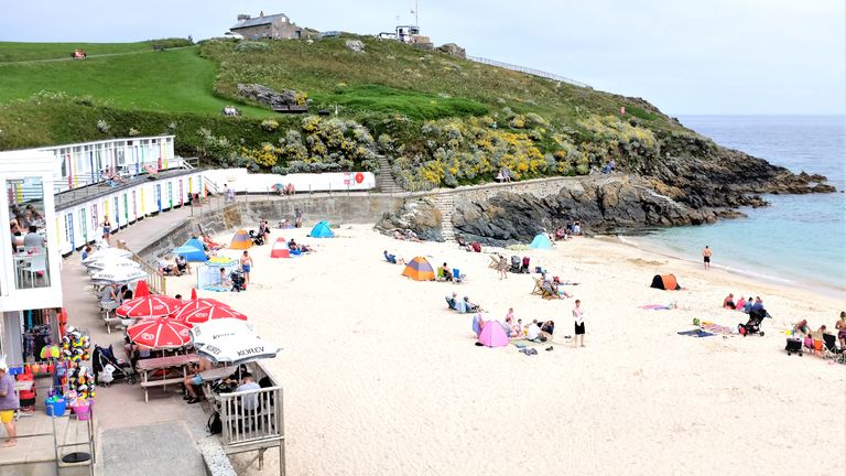 St. Ives, Cornwall, UK. June25, 2019. Holidaymakers enjoying the sheltered sand of Porthgwidden beach at St. Ives in Cornwall, UK.