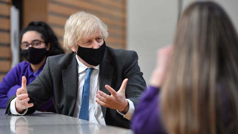 Prime Minister Boris Johnson speaks with Year 11 students in the canteen during a visit to Accrington Academy in Accrington, Lancashire, as they prepare for the return of all pupils on March 8. Picture date: Thursday February 25, 2021.