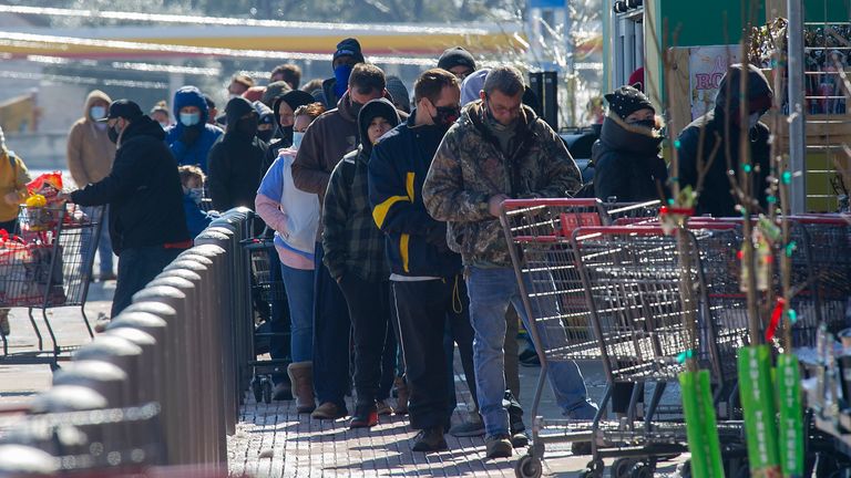 People in Austin queueing to enter a supermarket. Pic: AP