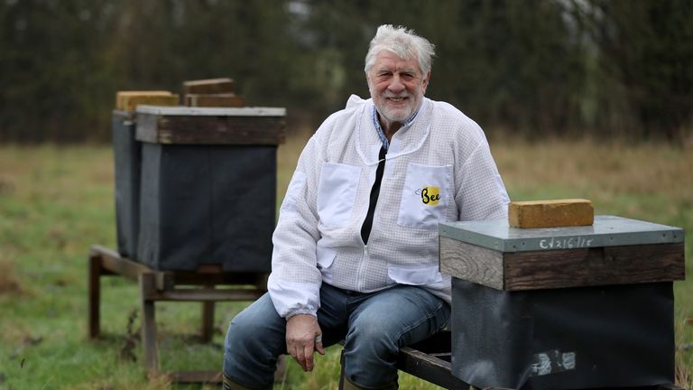 Beekeeper Patrick Murfet with some of his hives in an orchard near Canterbury