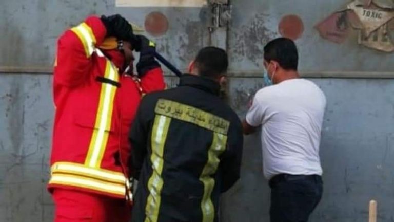 Picture of three people trying to open hangar 12. The man in the white t shirt on the right hand side is Imad Zahereldine who was one of the first on the scene trying to put out the fire in Hangar 12 at the port. This was taken moment before the explosion. 