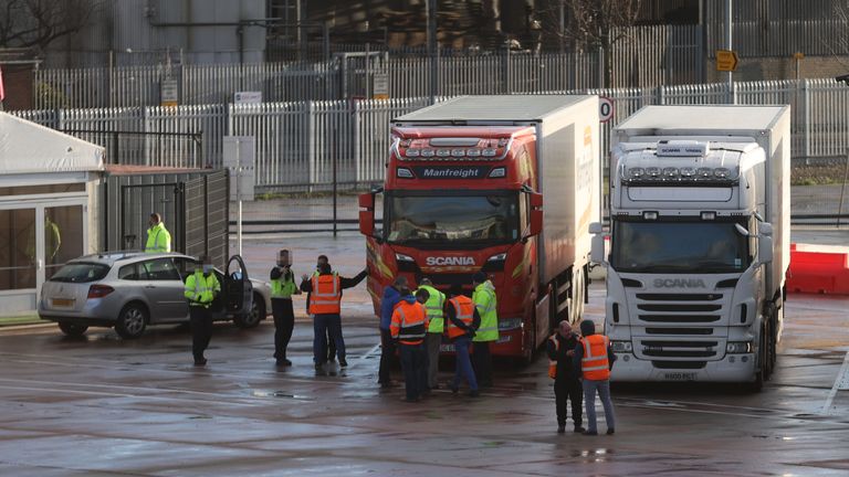 FACES OF BORDER FORCE OFFICERS AND VEHICLE NUMBER PLATE PIXELLATED BY PA PICTURE DESK Lorry drivers and officials talk at the DEARA site near Belfast Port, as the UK leaves the single market and customs union and the Brexit transition period comes to an end.