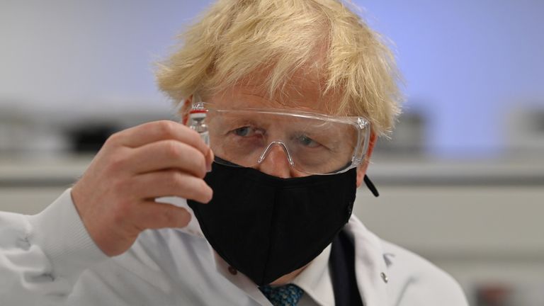 Prime Minister Boris Johnson holding a vial of the Oxford/AstraZeneca vaccine