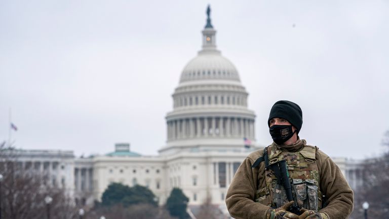 Member of the national guard patrol the area outside of the U.S. Capitol on the third day of the impeachment trial of former President Donald Trump at Capitol Hill, in Washington, Thursday, Feb. 11, 2021. (AP Photo/Jose Luis Magana)