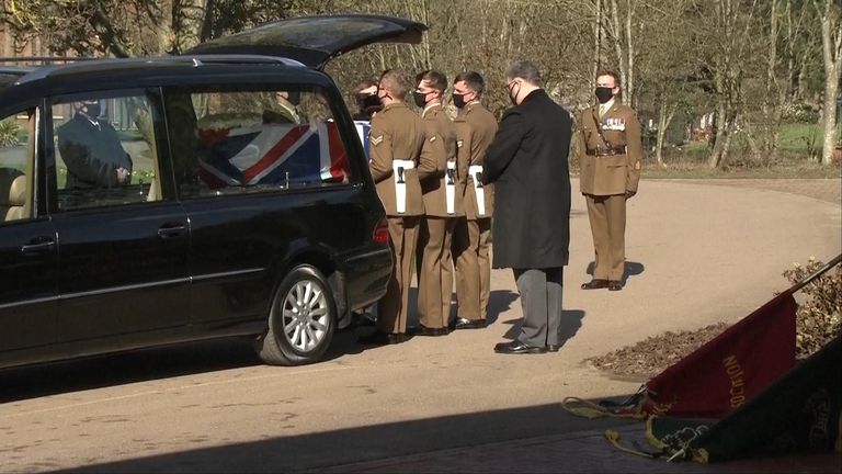 Soldiers lift Captain Sir Tom Moore&#39;s coffin from the hearse
