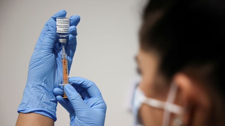 A health worker prepares an Astra Zeneca coronavirus vaccine injection in London