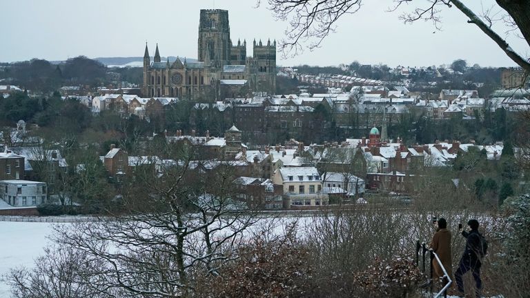People take pictures from Pelaw Wood of a snow covered Durham Cathedral