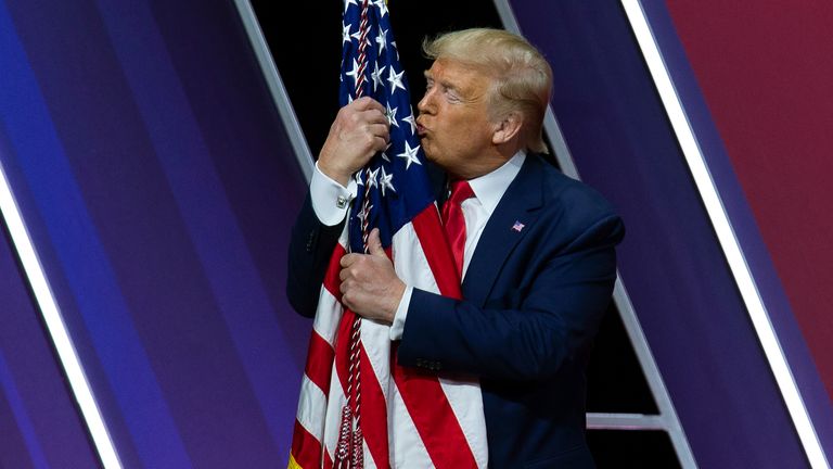 Donald Trump kisses the American flag after speaking at Conservative Political Action Conference, CPAC 2020. Pic: AP