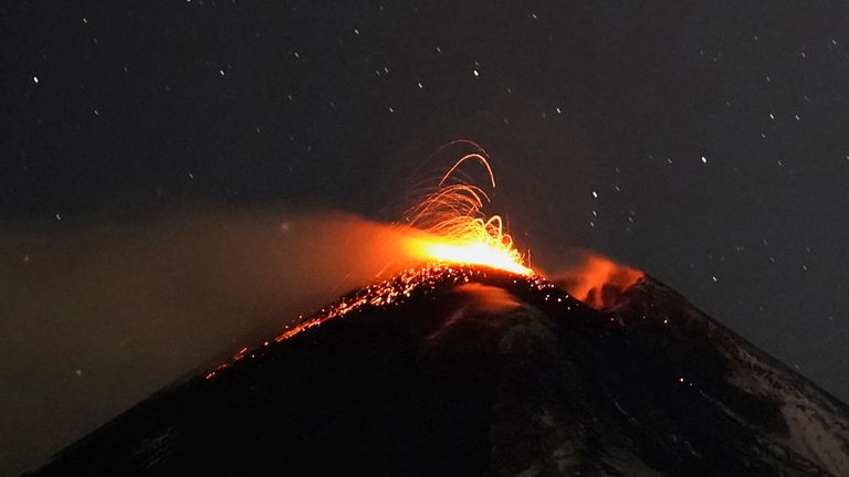 Large streams of red hot lava shoot into the night sky as Mount Etna, Europe&#39;s most active volcano, leaps into action, seen from the village of Fornazzo, in Catania, Italy, Feburary 15, 2021. REUTERS/Antonio Parrinello