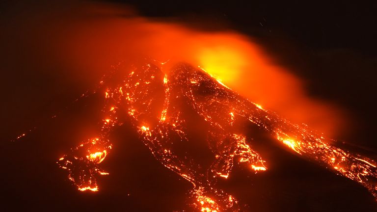 Streams of red hot lava flow as Mount Etna, Europe&#39;s most active volcano, leaps into action, seen from Giarre, Italy, February 16, 2021. REUTERS/Antonio Parrinello