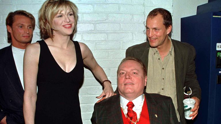 Magazine publisher Larry Flynt (in wheelchair) poses with the cast of the new film based on his life "The People vs. Larry Flynt" during a special screening of the film December 2 in Los Angeles. Shown (L-R) are Brett Harrelson, who portrays Jimmy Flynt, actress Courtney Love who portrays Larry Flynt&#39;s wife Althea and Woody Harrelson who plays Larry Flynt in the film.