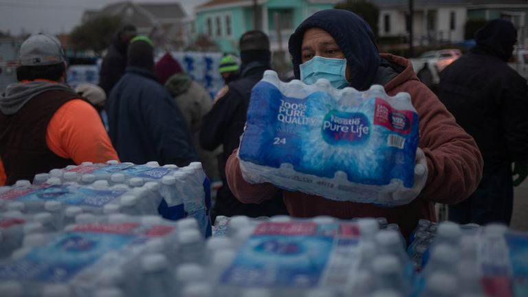 Volunteers help distribute water to local residents at a warming center and shelter after record-breaking winter temperatures, as local media reports most residents are without electricity, in Galveston, Texas, U.S., February 17, 2021. REUTERS/Adrees Latif