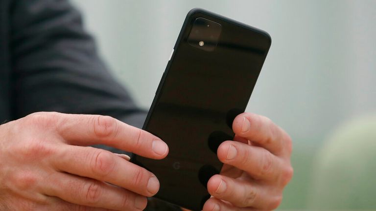 In this Tuesday, Sept. 24, 2019, photo Rick Osterloh, SVP of Google Hardware holds a new Pixel 4 phone while interviewed in Mountain View, Calif. (AP Photo/Jeff Chiu)


