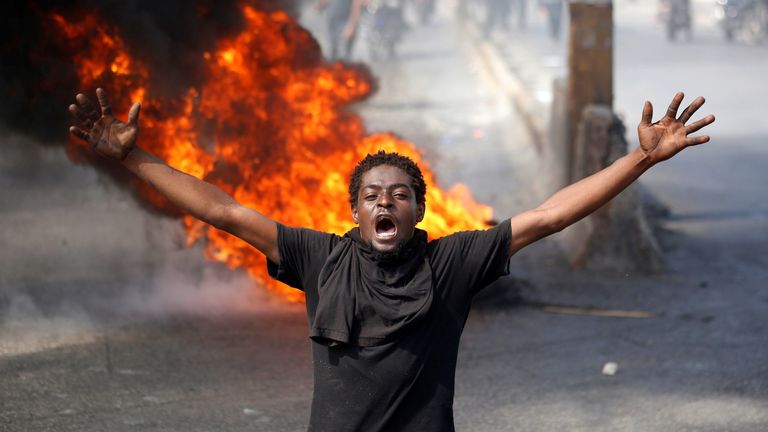 A demonstrator shouts past a barricade during a march protest against Haiti&#39;s President Jovenel Moise, in Port-au-Prince, Haiti February 14, 2021. REUTERS/Jeanty Junior Augustin 
