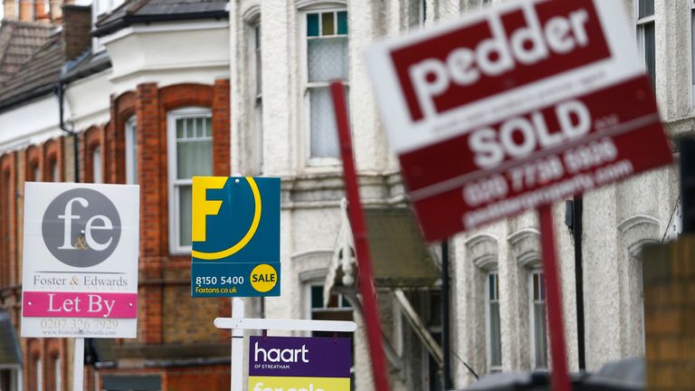 Estate agents boards are lined up outside houses in south London June 3, 2014