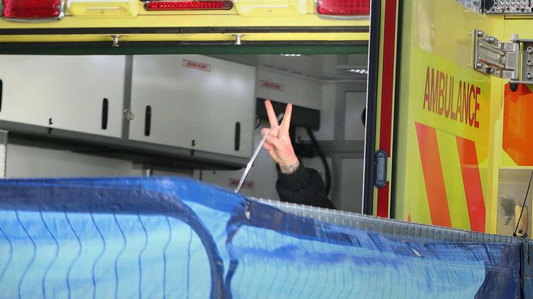 The final anti-HS2 protester flashes a V-sign from the back of an ambulance