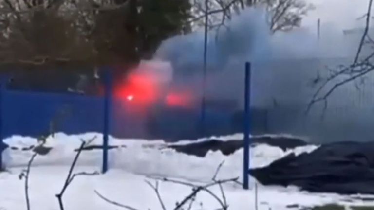 Fans set fire to the training ground by throwing flares. Pic: Sky Sports