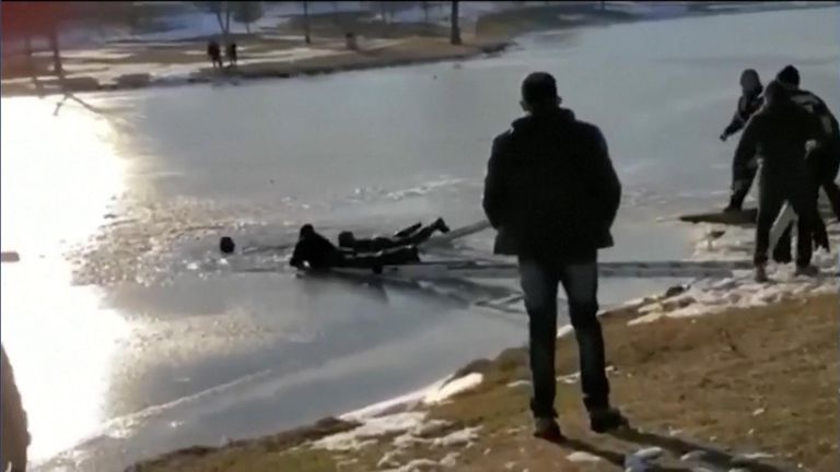 Rescuers save couple from frozen pond