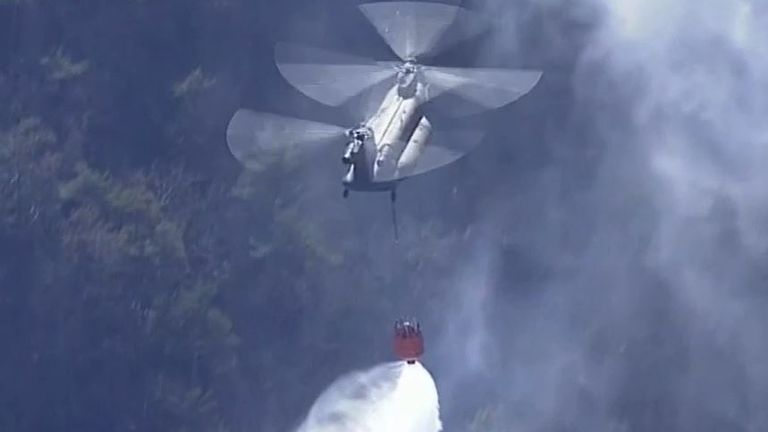 Helicopter crews drop water on wildfires in Japan