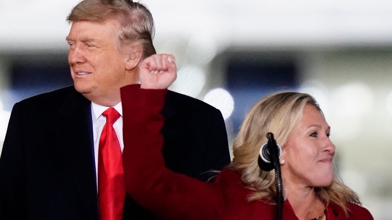 Rep. Marjorie Taylor Greene, R-Ga., speaks as President Donald Trump listens at a campaign rally in support of Senate candidates Sen. Kelly Loeffler, R-Ga., and David Perdue in Dalton, Ga., Monday, Jan. 4, 2021. (AP Photo/Brynn Anderson)