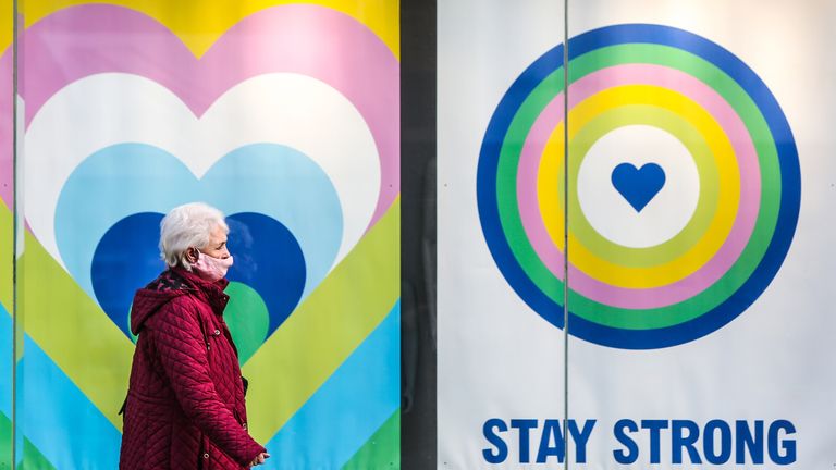 A woman wearing a protective face mask walks past a sign in a Primark shop window in Brighton that says &#39;Stay Strong&#39;, as the UK continues in lockdown due to the coronavirus pandemic. Picture date: Friday February 5, 2021.