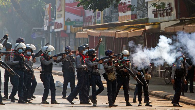 Riot police officers fire teargas canisters during a protest in Yangon