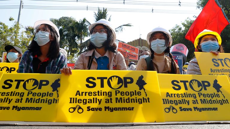  /// ...Mandalay University graduates hold posters that say ...Stop Arresting People Illegally at Midnight. Save Myanmar... during an anti-coup protest in Mandalay, Myanmar Sunday, Feb. 14, 2021. Daily mass street demonstrations in Myanmar are on their second week, with neither protesters nor the military government they seek to unseat showing any signs of backing down from confrontations. (AP Photo)....