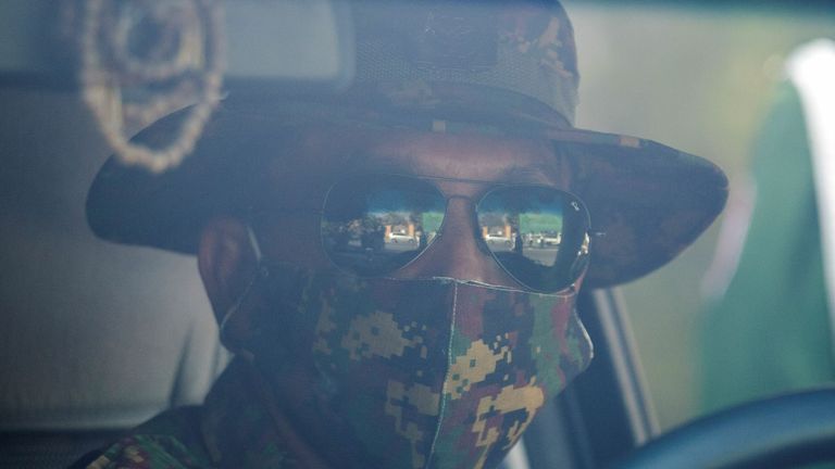 Myanmar soldier looks on through a windshield as he sits inside a vehicle in front of a Hindu temple in the downtown area in Yangon, Myanmar, February 2, 2021. REUTERS/Stringer