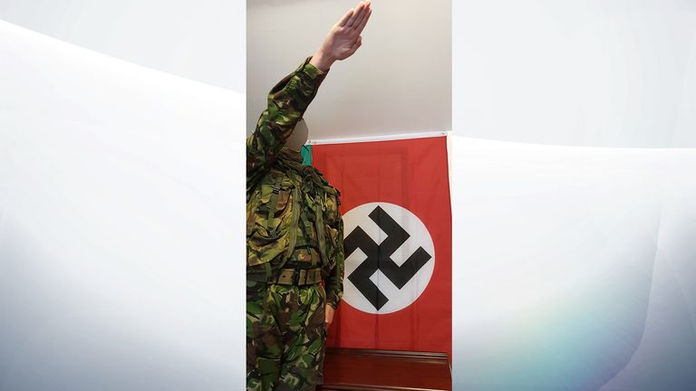 The boy was pictured saluting in front of a Nazi flag