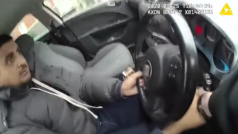 Bodycam footage shows the officer's hand trapped inside the car.  Photo: West Midlands Police