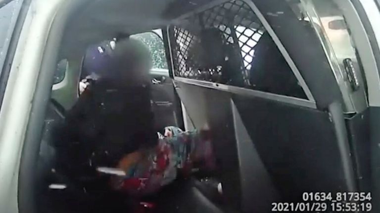 In this this Jan. 29. 2021 still frame from a Rochester Police Department body-camera video, a nine-year-old girl is handcuffed in police custody in a police cruiser after police used pepper spray on her as she screamed for her father. Rochester, New York police released two body-camera videos of officers restraining the girl. According a local news outlet, Rochester Mayor Lovely Warren expressed her concern for the child. (Rochester Police Department via AP)