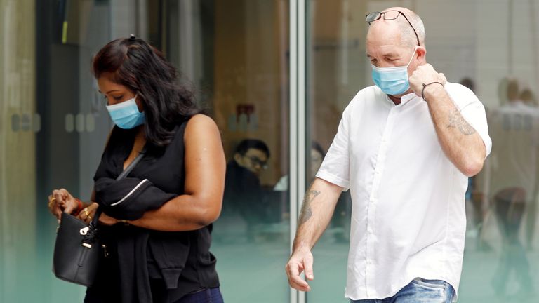 Briton Skea Nigel and partner Agatha Maghesh Eyamalai arrive at the State Courts for a hearing after breaking coronavirus disease (COVID-19) quarantine regulations in Singapore February 15, 2021. REUTERS/Edgar Su