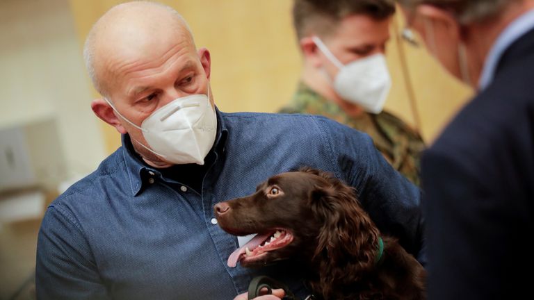 A researcher at Hanover university&#39;s vet clinic presents Joe, the 1-year-old Cocker Spaniel which is able to detect COVID-19 in humans&#39; saliva samples, in Hanover, Germany, February 3, 2021. REUTERS/Hannibal Hanschke REFILE - CORRECTING YEAR.