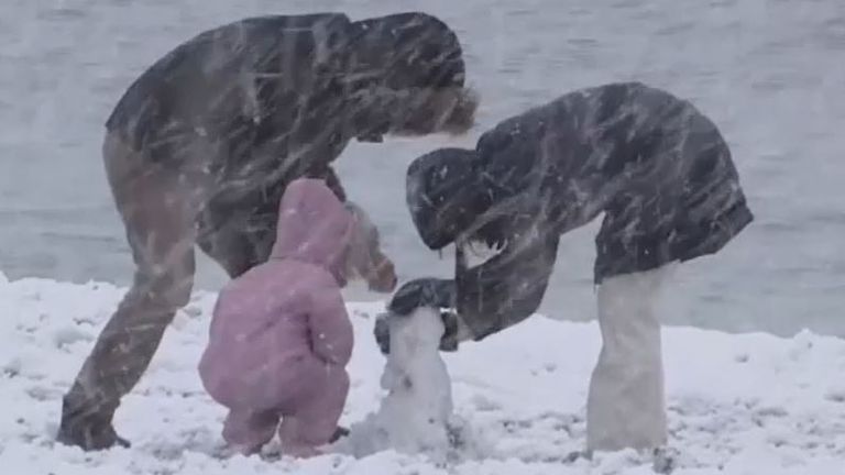 People build a snowman on the beach in Greece