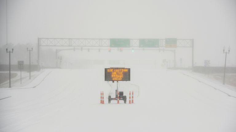 A sign warns motorists after a sudden heavy bout of snow and frozen rain on MS Highway 463 in Madison