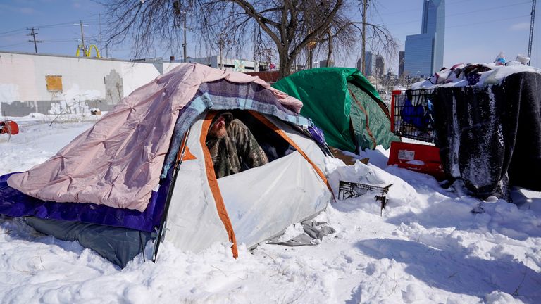 James Derrick peeks out of his tent during record breaking cold weather in Oklahoma City