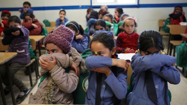 Syrian refugee children at a camp in Jordan get a lesson on hygiene during the pandemic