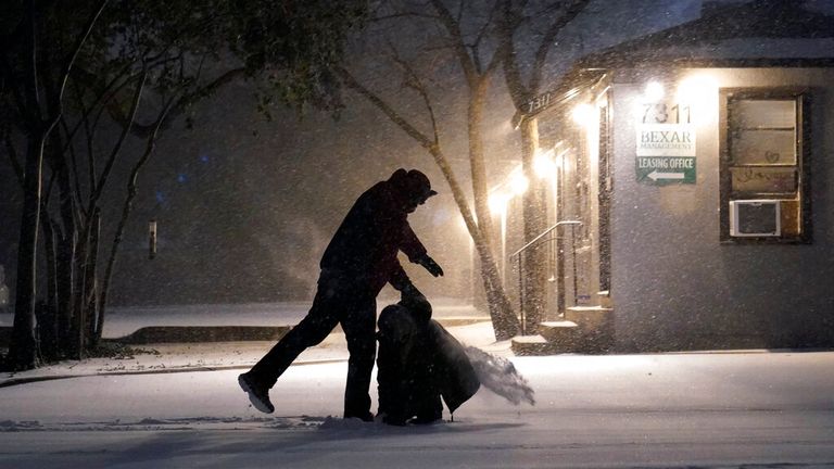 Two people play in the snow in San Antonio, Texas