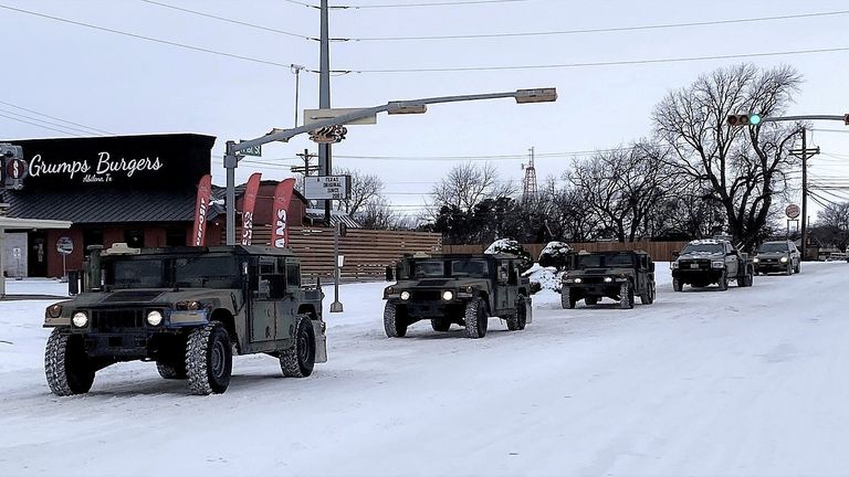 Military vehicles from the Texas Military Department of the Texas National Guard, tasked to transport residents to designated warming centers and other required duties, form a convoy in Abilene, Texas, U.S. February 16, 2021. Greg Jaklewicz/Reporter-News/USA Today Network via REUTERS. NO RESALES. NO ARCHIVES. MANDATORY CREDIT