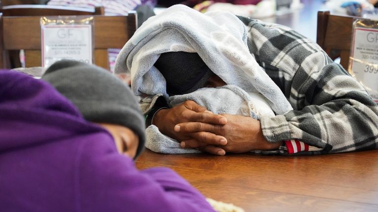 People take shelter at Gallery Furniture store which opened its door and transformed into a warming station