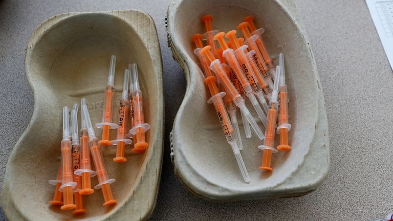 Vials of the AstraZeneca vaccine and loaded syringes wait to be administered to homeless persons at the Welcome Centre in Ilford, east London, Friday, Feb. 5, 2021. (AP Photo/Frank Augstein)