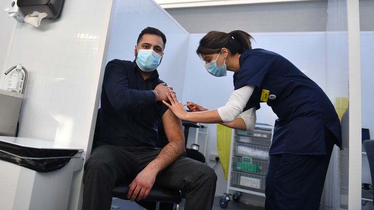 Pharmacist Josh Athwal receives his vaccine