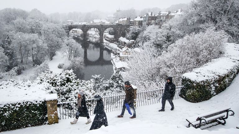 Les gens marchent près du viaduc de Knaresborough à Knaresborough, Yorkshire du Nord après la chute de neige pendant la nuit.  Date de la photo: mardi 2 février 2021.