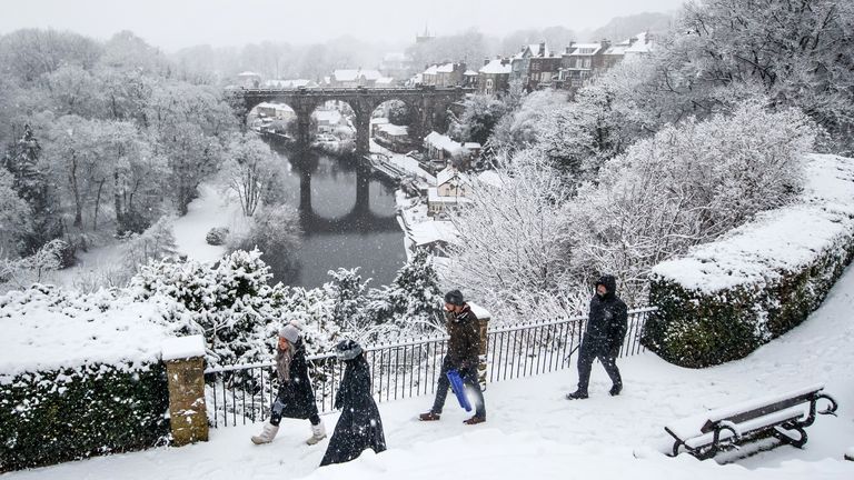 People walk near Knaresborough Viaduct in Knaresborough, North Yorkshire after snow fell overnight. Picture date: Tuesday February 2, 2021.