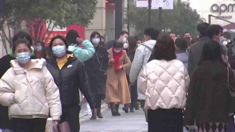 People walking in the street in Wuhan, China.