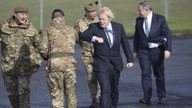  Prime Minister Boris Johnson greets troops alongside Northern Ireland Secretary Brandon Lewis (right) and Brigadier Chris Davies, Commander 38 (Irish) Brigade (left), during a visit to Joint Helicopter Command Flying Station Aldergrove in Northern Ireland