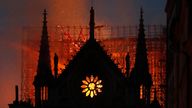In this April 15, 2019, file photo, flames and smoke rise from Notre Dame Cathedral as it burns in Paris. The cathedral stands crippled, locked in a dangerous web of twisted metal scaffolding one year after a cataclysmic fire gutted its interior, toppled its famous spire and horrified the world. (AP Photo/Thibault Camus, File)