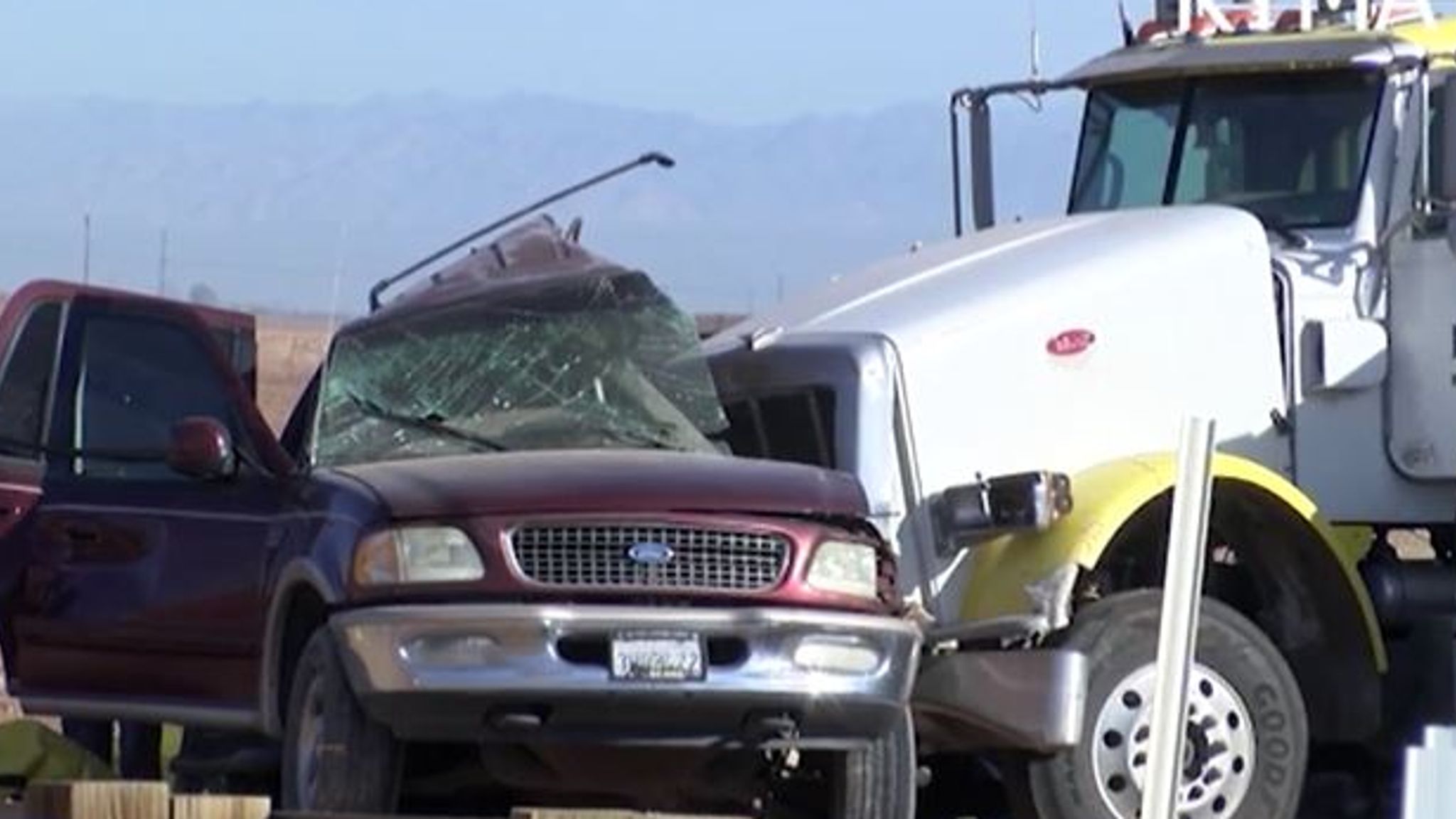 At least 13 people die after SUV hits truck carrying gravel near US