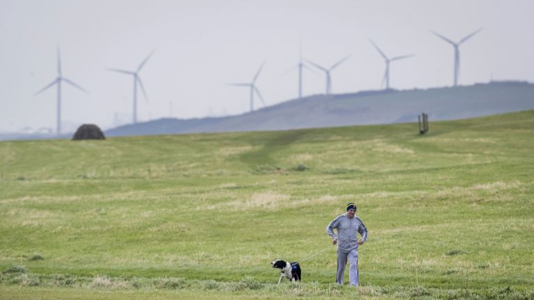 File photo dated 15/10/17 of man walking his dog near Whitehaven in Cumbria. Approved plans for a new coal mine near the Cumbrian town will produce more emissions than any of the others currently open in the UK, a climate group has warned. Issue date: Saturday January 30, 2021.