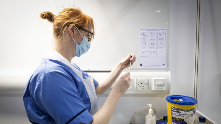 Nurse Eleanor Pinkerton prepares a coronavirus vaccine to be given to a health and care staff member at the NHS Louisa Jordan Hospital in Glasgow, as part of a mass vaccination drive by NHS Greater Glasgow and Clyde. Picture date: Saturday January 23, 2021.